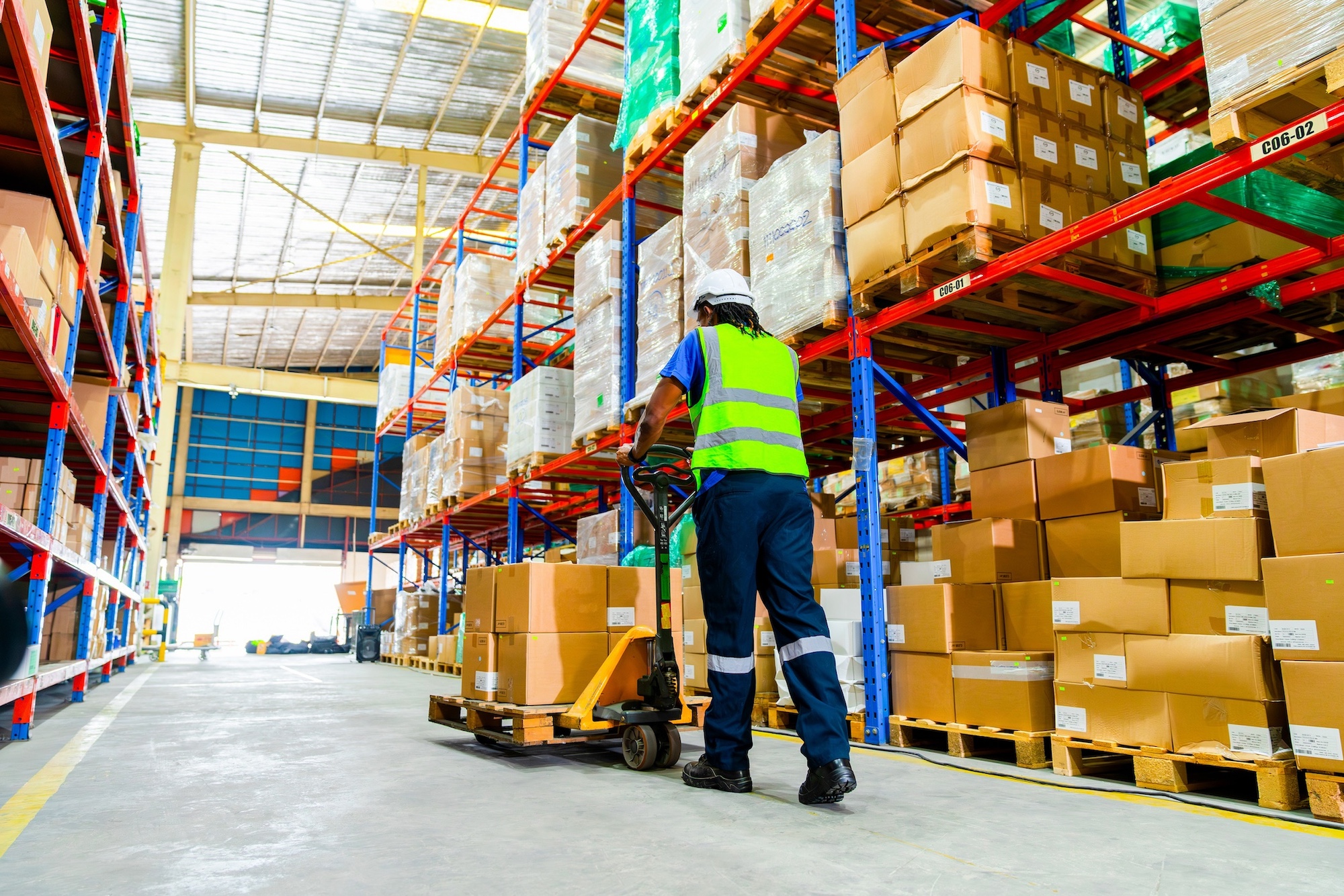 Warehouse labor moving freight using a pallet jack